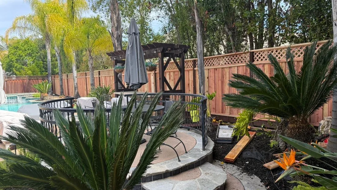 Redwood fence behind a poolside patio